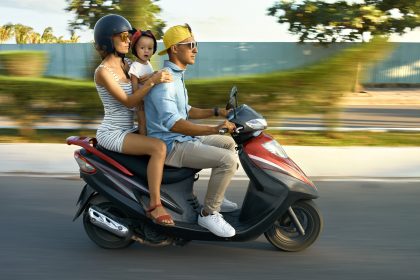 kid riding motorcycle with dad