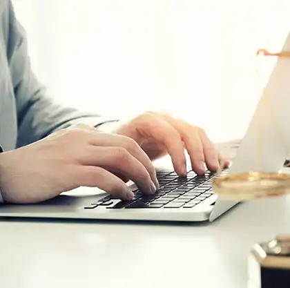 Hands typing while researching personal injury attorneys online