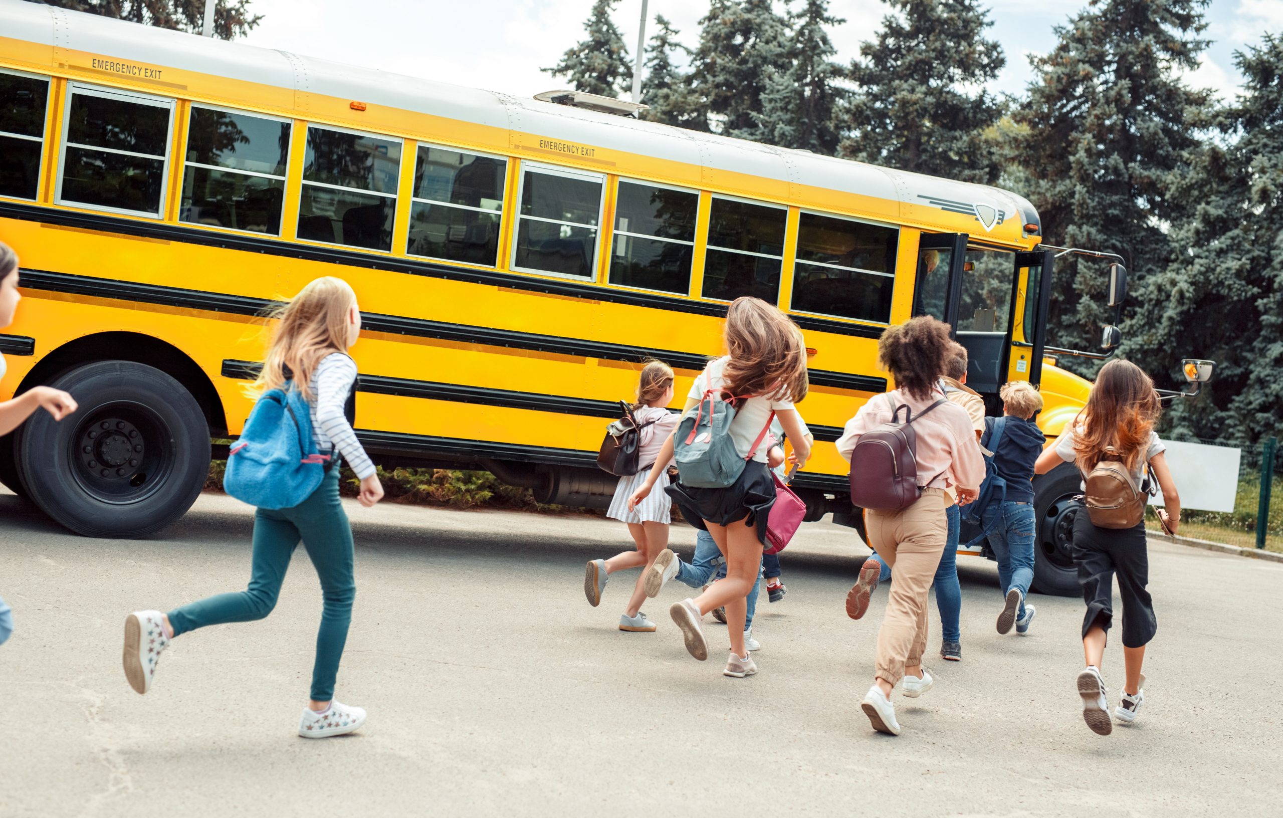 California-Back-to-School-Safe-Driving-Guide-2019-Classmates-running-to-school-bus-back-view-late-scaled-1.jpeg