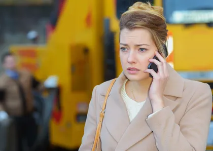 A woman calling a personal injury lawyer after a commercial vehicle accident