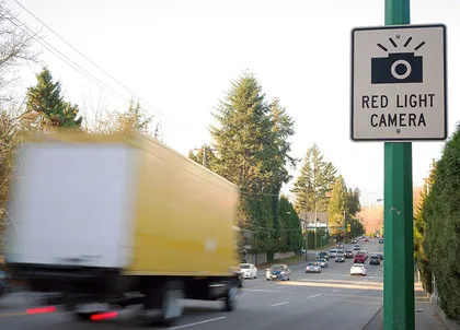 Sign indicating red light camera installed