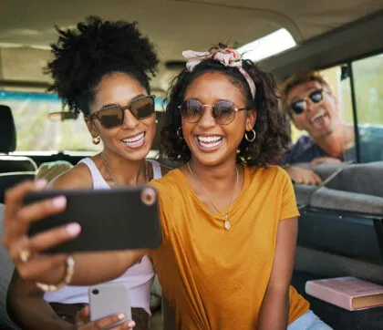 Friends enjoying a safe road trip after completing an automobile safety checklist