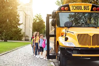 children boarding a school bus underscoring transportation safety and injury prevention