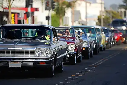 classic cars cruising on a street illustrating safe-speed awareness to prevent traffic injuries