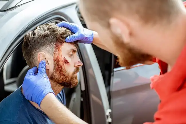A medic giving emergency medical assistance to an injured driver after an Uber accident in Napa County