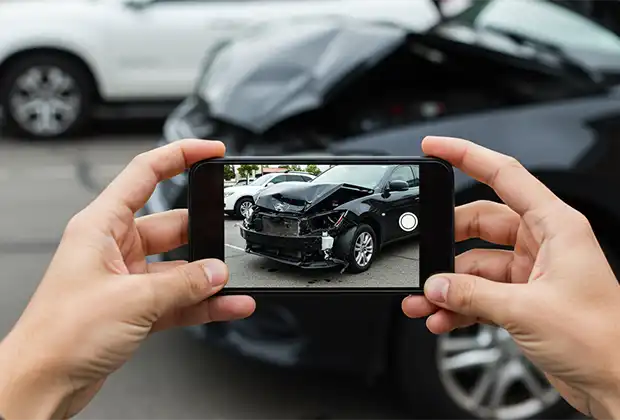 A woman is taking a picture as evidence for a legal claim