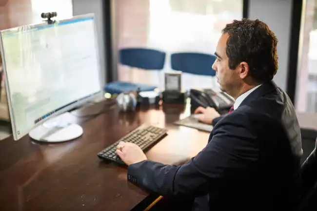 AK lawyer in Lassen County reviewing car accident case details on the computer