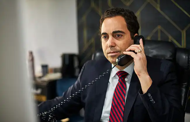 AK personal injury lawyer speaking to a client on the phone in Glendora