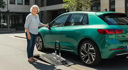 Smiling senior woman beside an accessible car with a mobility ramp