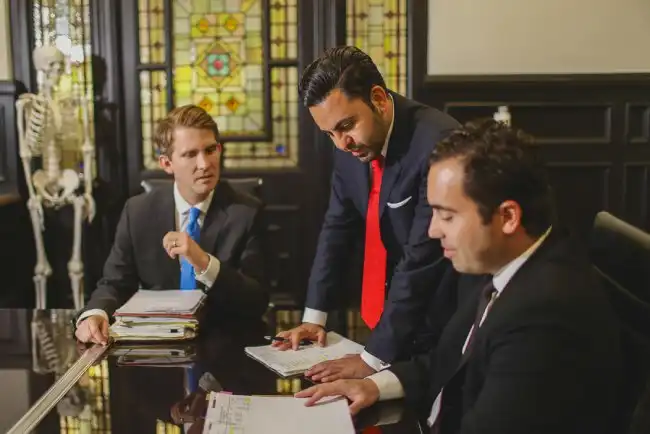 Team of personal injury lawyers in Hawthorne reviewing case files in an office