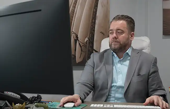 AK Lawyers attorney at desk working on computer