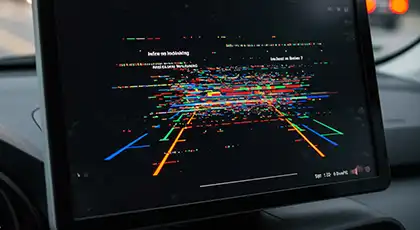 In-car display showing a complex, glitchy visual from a self-driving vehicle’s sensor system