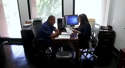 Injured client meeting with a lawyer in an office to discuss legal options