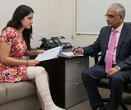a woman consulting an insurance agent for her medical expenses after a fender bender