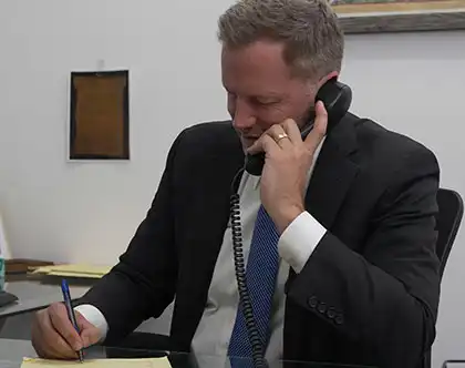 AK Lawyer on the phone with a workplace accident victim