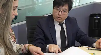 Two AK lawyers reviewing documents together during a post-accident legal consultation