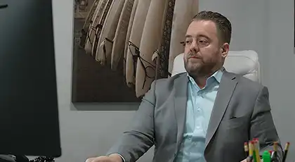 AK lawyer answering client questions on his computer