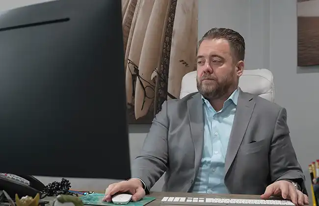 AK lawyer answering client questions on his computer