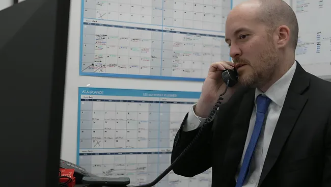 AK lawyer speaking on the phone with a client involved in a truck accident