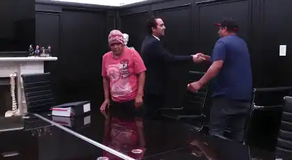 Car accident attorney shaking hands with a client in a law office