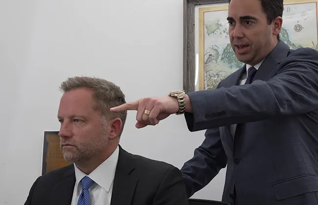Two AK lawyers in formal attire discussing a case in Moreno Valley