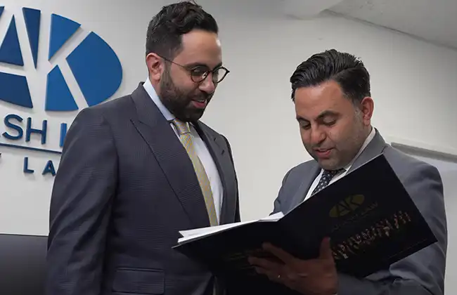 Two attorneys at a law office reviewing case documents in Los Angeles