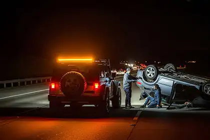 a jeep with hazard lights on to alert oncoming traffic of crash or accident
