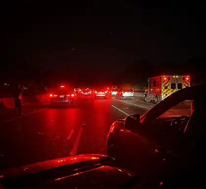 couple of cars with hazard lights turned on due to an accident in the area