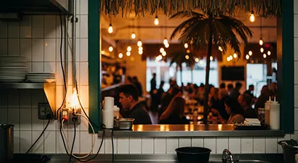 Restaurant with exposed wiring and overcrowded seating