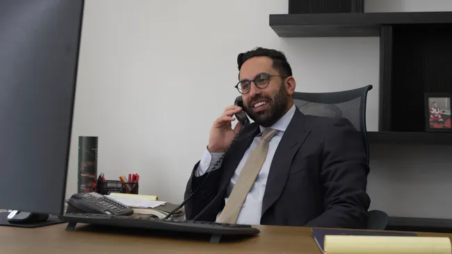 AK Lawyer is talking on the phone with the client involved in a car accident case in El Cajon