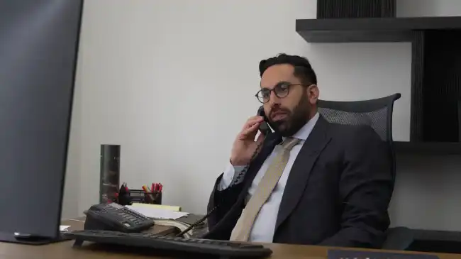 AK lawyer speaking with a client about a pedestrian accident case over the phone