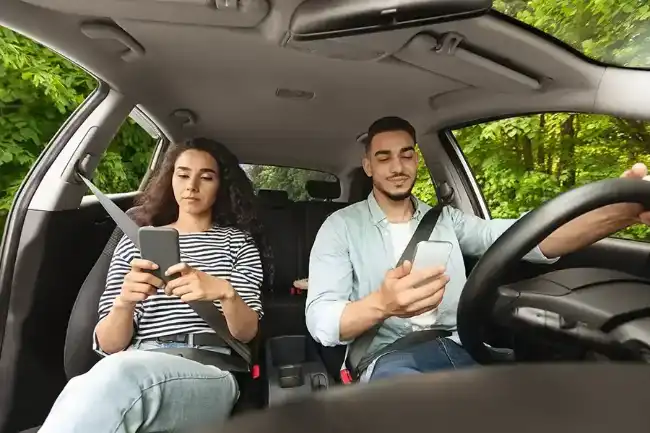 Accident risks as Lyft driver and passenger both distracted on phone