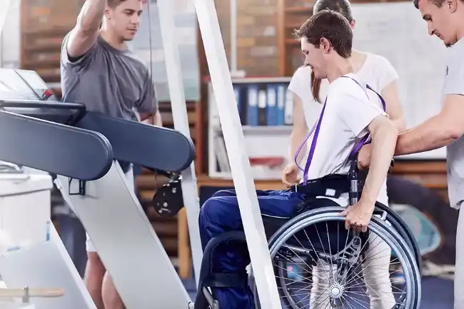 Catastrophic injury patient in a wheelchair receiving therapy assistance