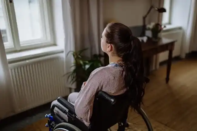 Catastrophic injury victim in a wheelchair reflecting recovery journey
