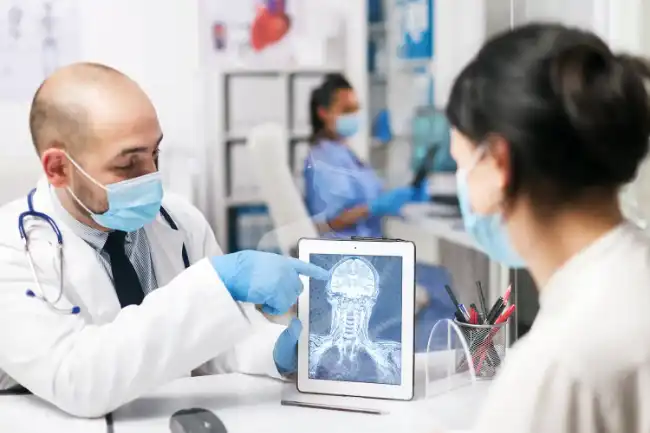 Doctor discussing injuries with patient from motorcycle accident