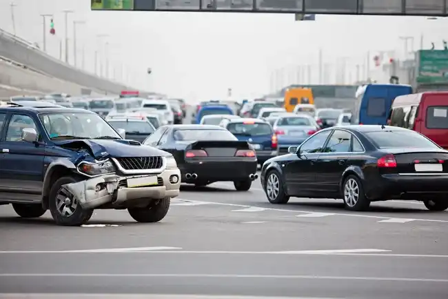 Freeway accident showing car with right front side damage