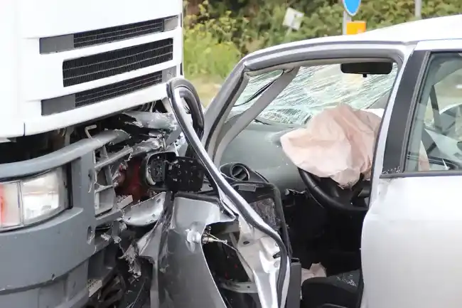Truck accident showing head-on collision between truck and car