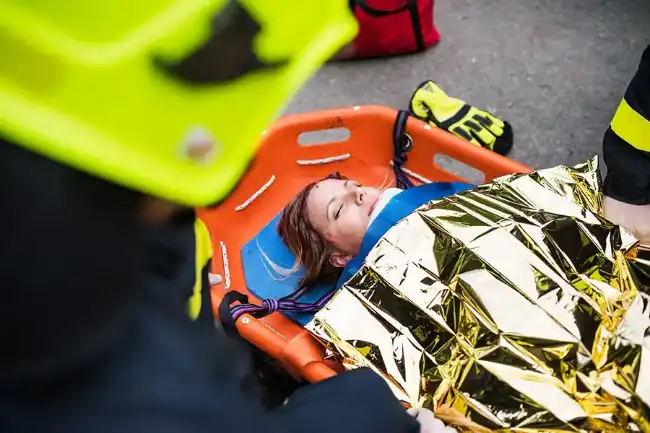 Truck accident victim placed on stretcher by rescuers