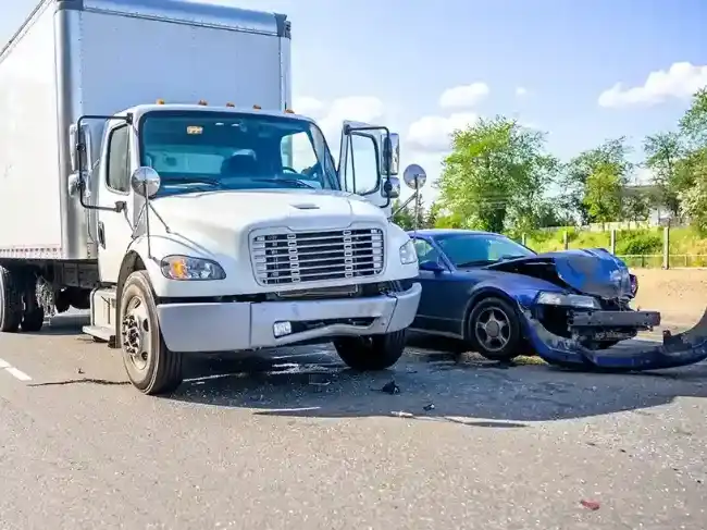 Truck accident with damaged car beside it