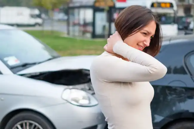 Woman holding her neck after an accident in Kern County