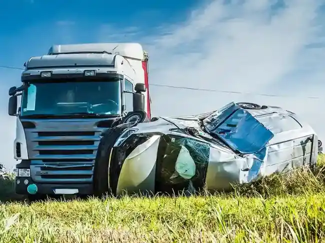 Wrecked car after being involved in a truck accident