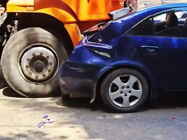 Wrecked car after being involved in truck accident