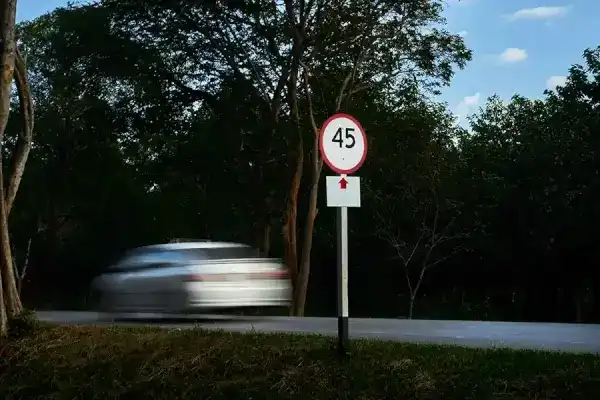 a Tesla car speeding past the speed limit
