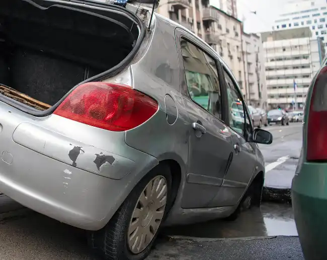 a car caught in a pothole on the road