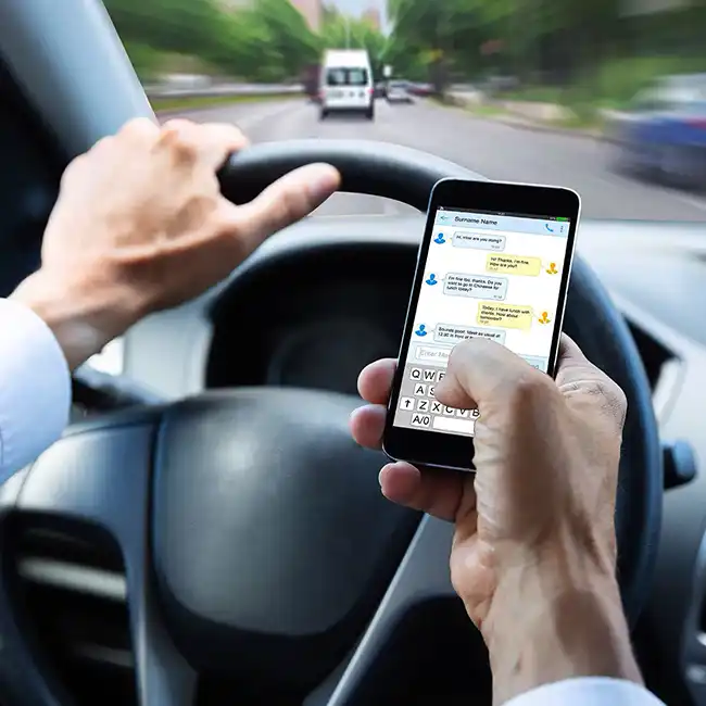 man distracted and using phone while driving