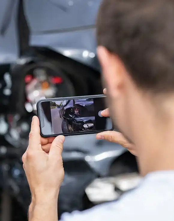 man documenting the UPS truck accident scene by taking pictures