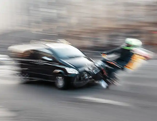 motorcycle rider being hit by a car