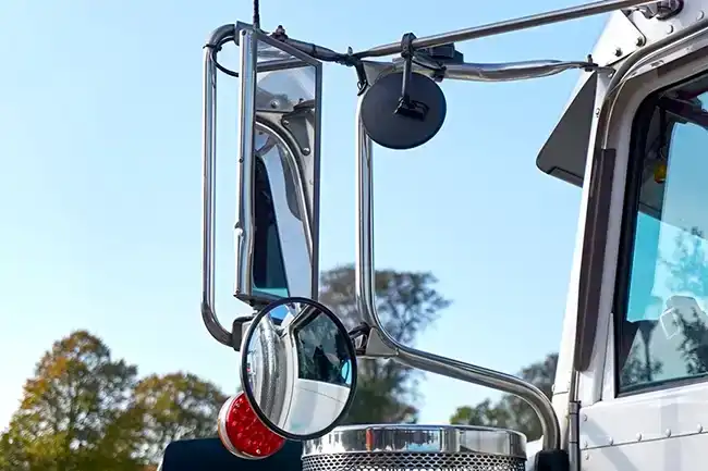 A large side mirror of a truck