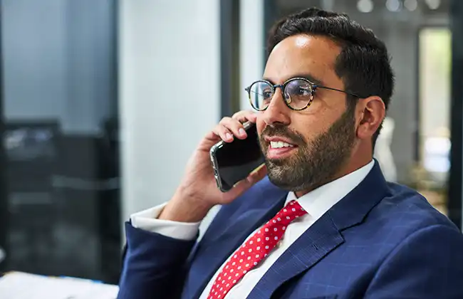 AK lawyer speaking on the phone with a car accident victim in Madera County