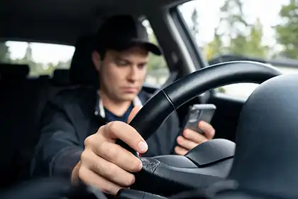 An-Uber-driver-busy-looking on the maps in his phone while driving near Bellflower